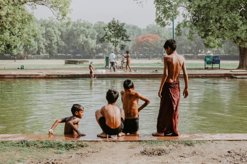Young boys bathe in a river new India gate, Delhi